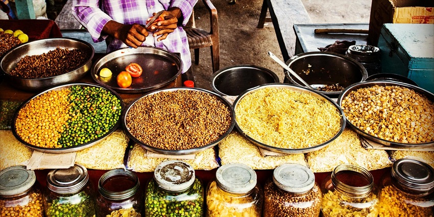 The image of the street vendor selling the local snacks on a makeshift shop in Delhi