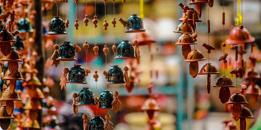 Handmade ornaments of various kinds hung on a stall in a Bali market for shopping