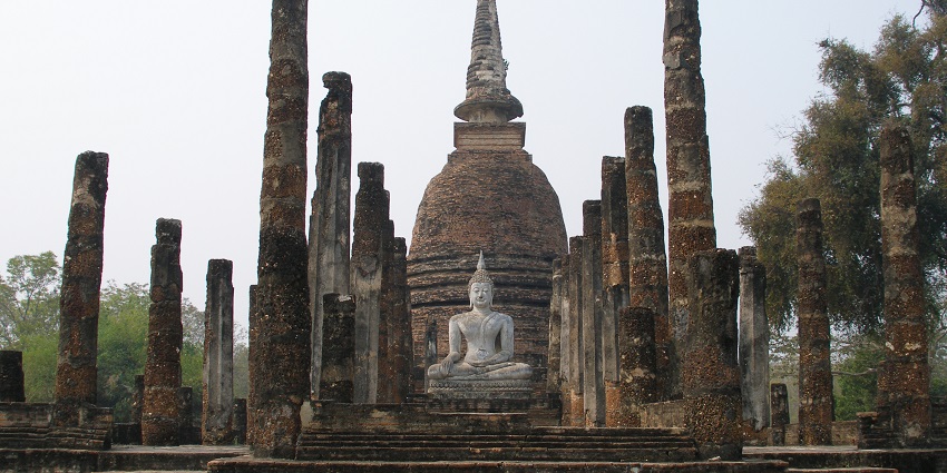 Beautiful views of the historical Sukhothai Buddhist vihar with an idyllic statue of Buddha