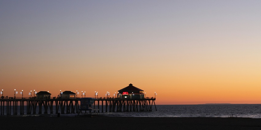 A serene glimpse of the sun setting down near the beach at Sunset Lounge and Bar.