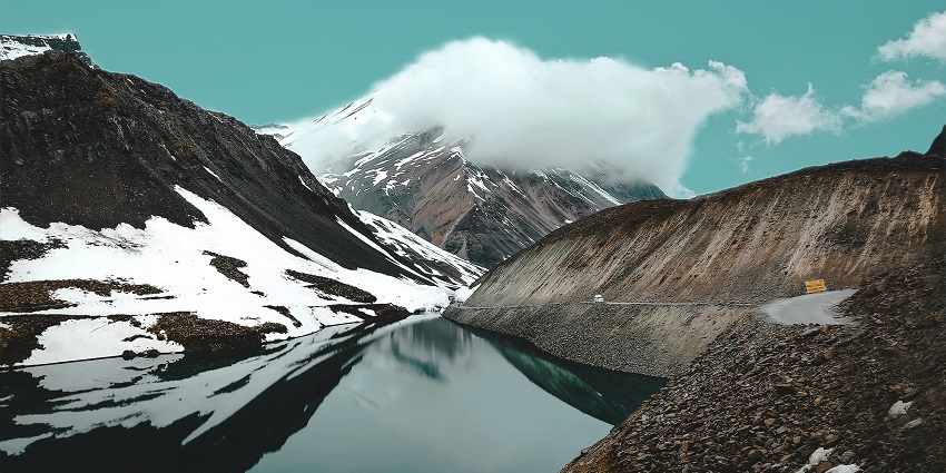 A breathtaking view of Suraj Tal featuring shimmering blue waters and majestic peaks.