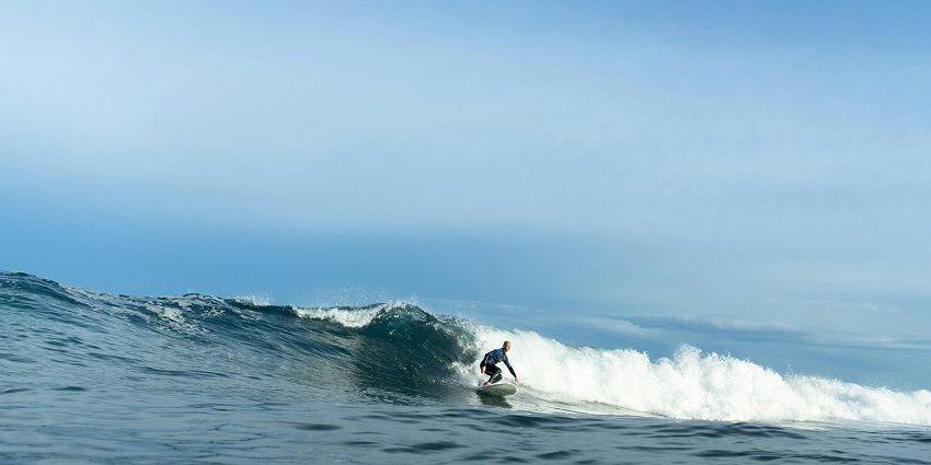 Person surfing on the sea, demonstrating the thrill of water sports in Vietnam.
