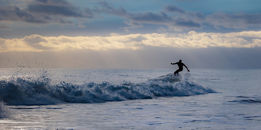 Surfing, one of the best water sports in Maldives, offers a spectacular backdrop to experience.