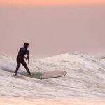 A man surfing on the wave one of the best water sports in Vietnam on Trip.