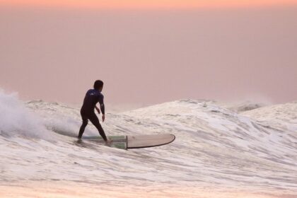 A man surfing on the wave one of the best water sports in Vietnam on Trip.