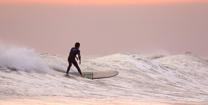 A man surfing on the wave one of the best water sports in Vietnam on Trip.