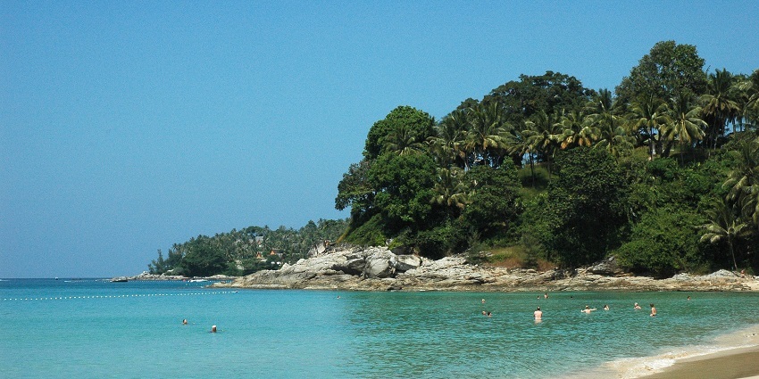 A view of shores and azure waters of Surin Beach, one of the best beaches in Phuket.