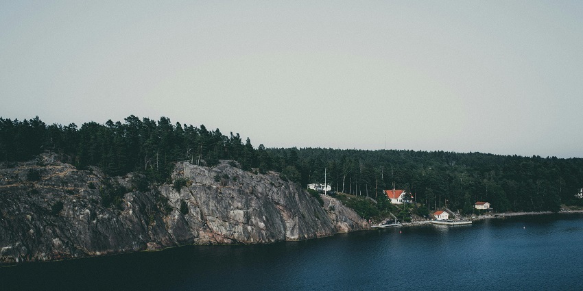 A fascinating view of a body of water in Sweden encircled by lush green mountains.