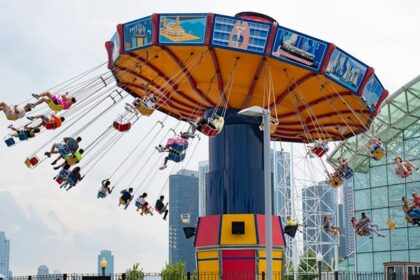 People enjoying at swing carousel with scenic views - theme parks in Malaysia