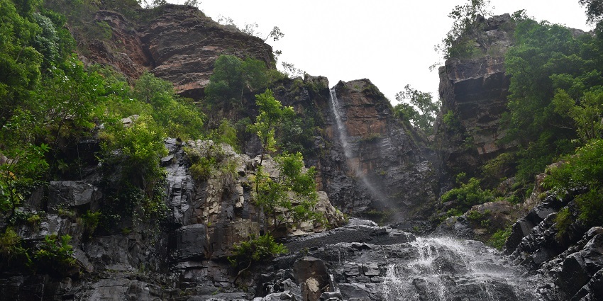 Picturesque view of sparkling water cascading down the rocks, ideal spot for nature lovers