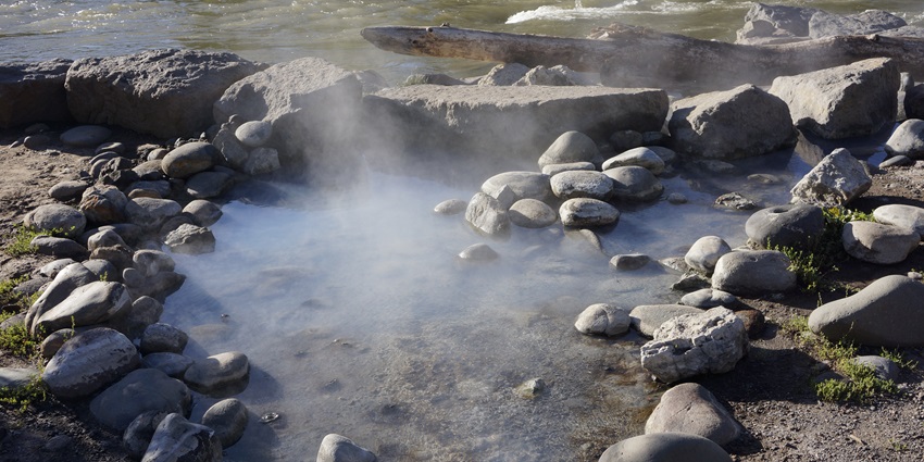 Image of a naturally formed Hot spring amidst the cold hills of the mountain