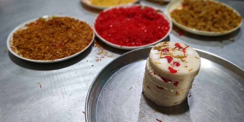 Tekeli Pitha, one of the best street foods in Guwahati, has a soft, spongy texture with a hint of sweetness.