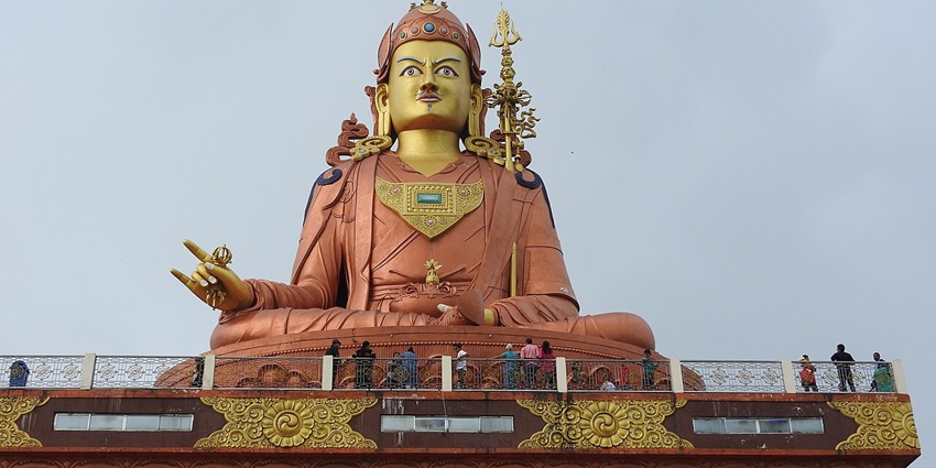 A picture of a majestic statue of a Buddhist deity, located near the Borong Hot Spring