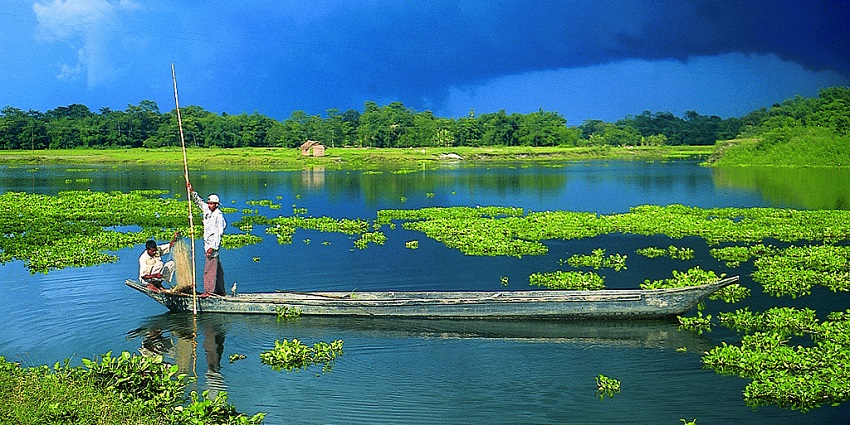 Snapshot of a man in a boat in the lake in Majali–Places to visit in Majuli, Assam