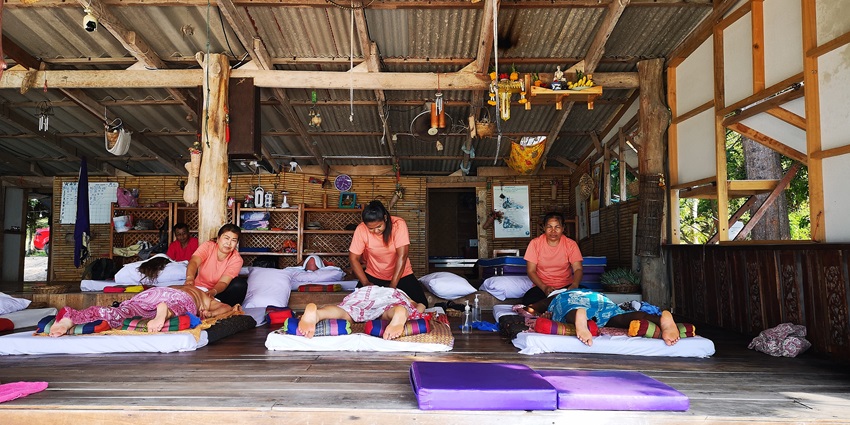 People relaxing while getting the traditional Thai massage at the Koh Lanta Island