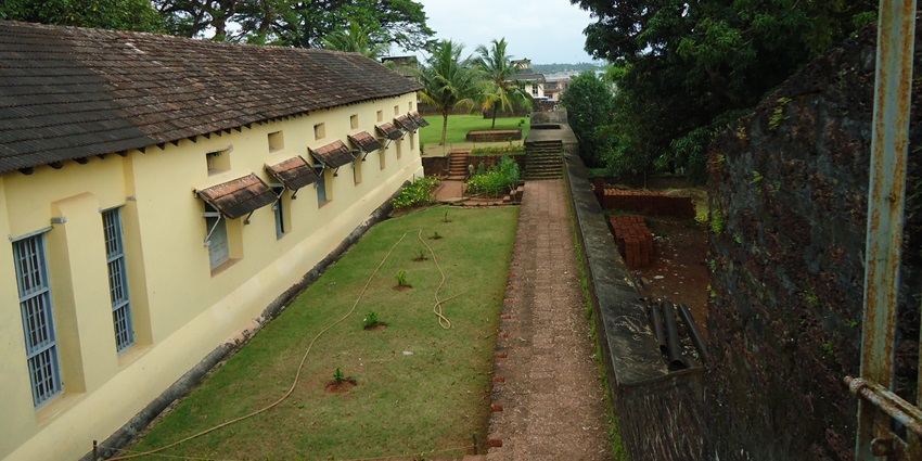View outside the side wall of the fort, surrounded by a verdant garden adding to its charm
