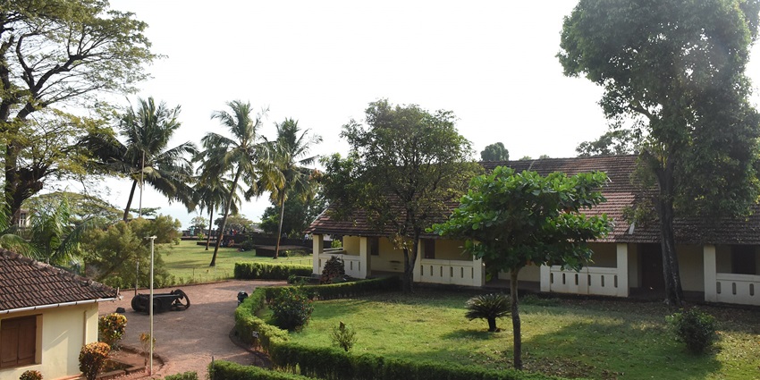 An aerial picture of a building near the St. Angelo Fort with a lot of greenery nearby and beautiful gardens