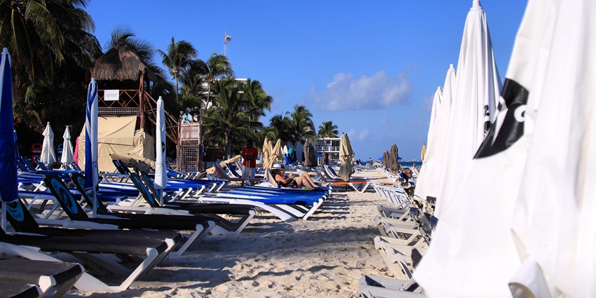 A picture of beach chairs placed in front of a beach for tourists to soak up the sun