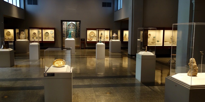 An enchanting view of an inside of a museum with different sculptures on display in it.