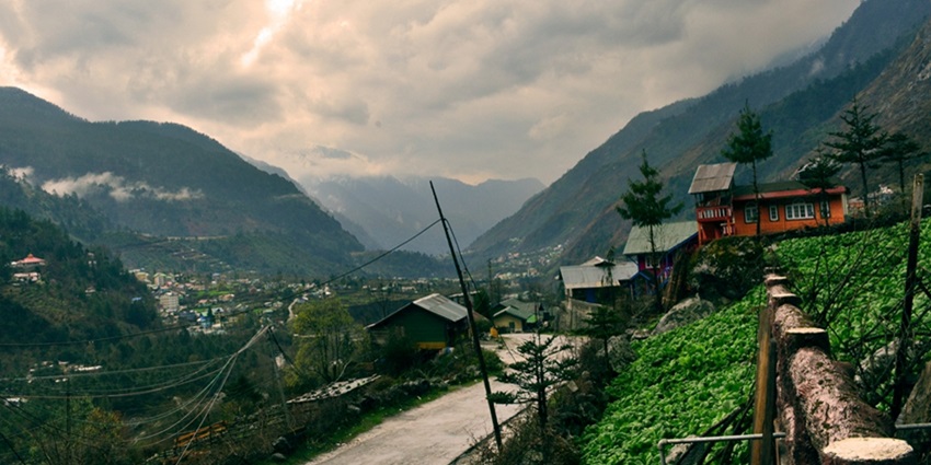 Tholung Trek Alt Text: A beautiful village with mountains in the background