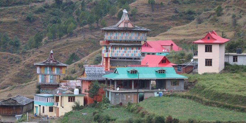 A glimpse of the iconic Thub-Chog Gatsel Ling surrounded by greenery and peaks.