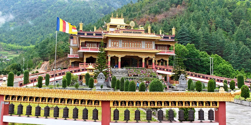 A picture of a majestic Buddhist Monastery in Dirang with lush mountains in the background
