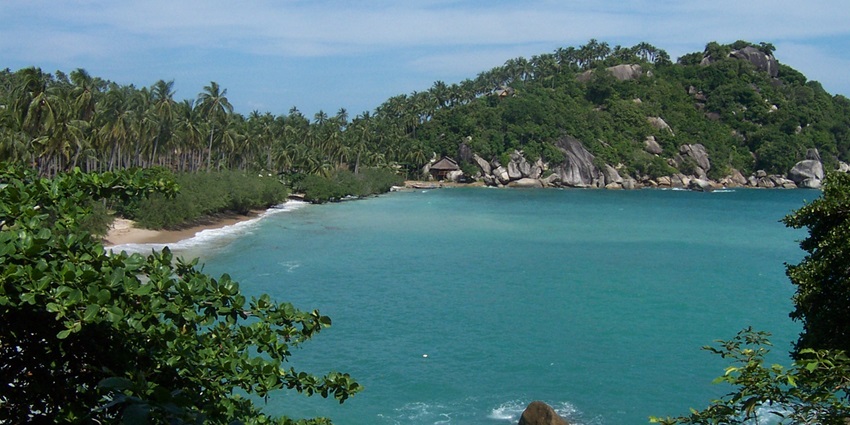 Stunning Tien Beach view with turquoise waters, soft sand, and lush tropical greenery.