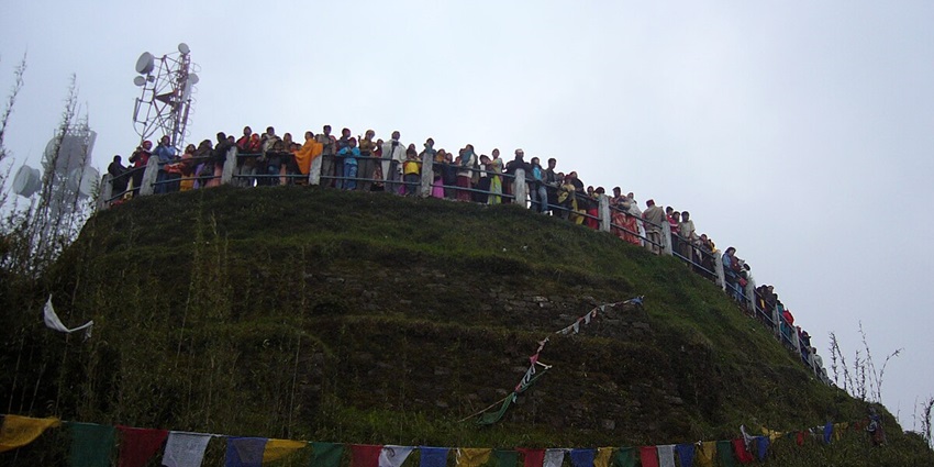 Tourist standing on the Tiger hill of Darjeeling, one of the ideal places for an nature retreat