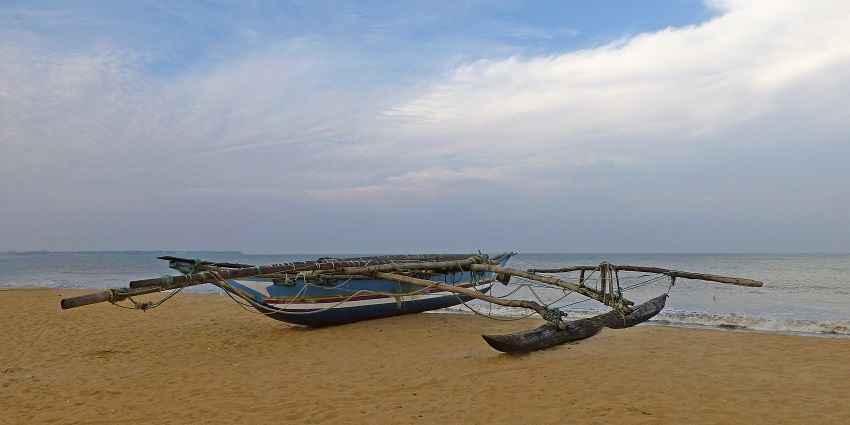 Traditional pirogue boat on Negombo Beaches, reflecting local fishing culture.