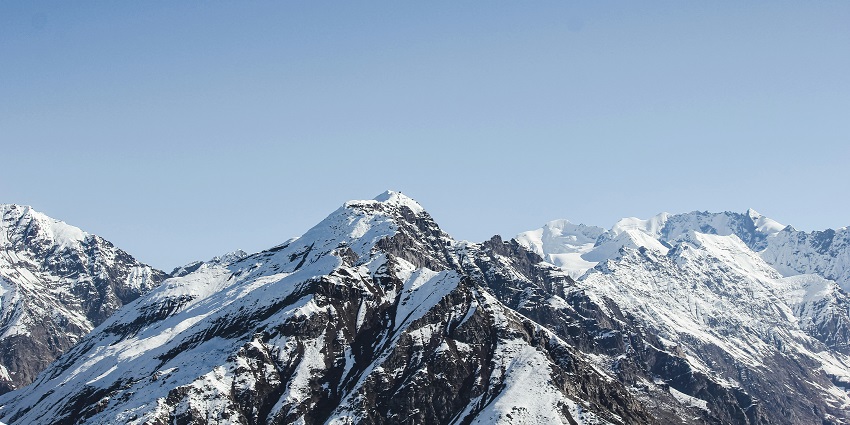 A serene view of majestic mountains covered with snow in Tingchim, an idyllic spot.