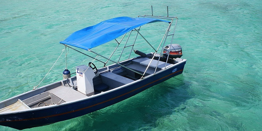 A boat on the clear waters of Salang Beach at Tioman Island, a Malaysian Island.