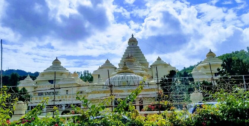 A fascinating view of a white historical monument surrounded by greenery during the day.