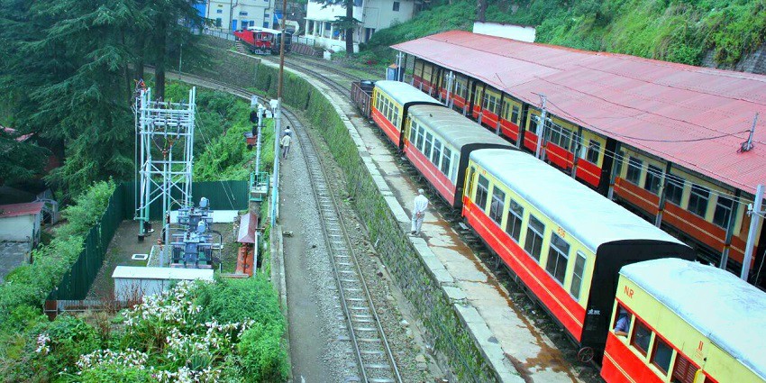 A picture of a toy train halting at a station in Shimla
