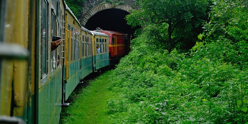 A picture of a toy train halting at a station in Shimla