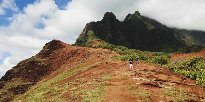 Person hiking outdoors amidst clouds, reflecting the adventure of hiking in Vietnam.