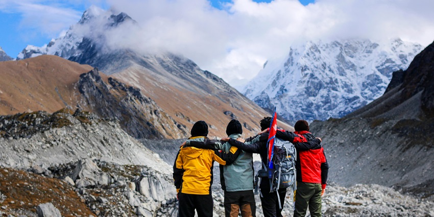 Trekkers standing atop a mountain and enjoying views