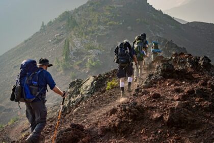 A view of hikers hiking through the unconventional trails surrounded by giant peaks.