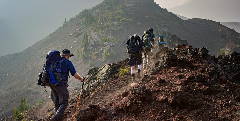 A view of hikers hiking through the unconventional trails surrounded by giant peaks.