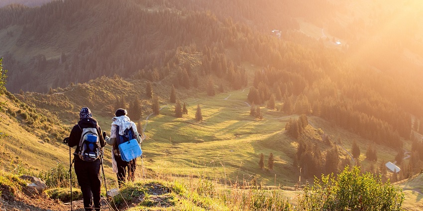 People climbing a mountain during daytime