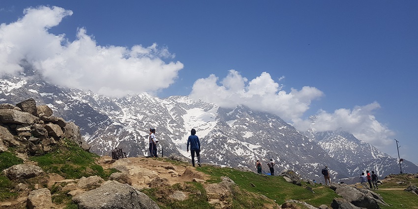 Scenic view of Triund trek in Himachal Pradesh, showcasing lush greenery and mountains.