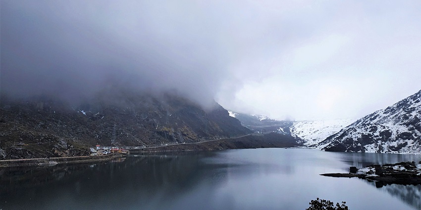 A mesmerising view of the Tsomgo Lake with a backdrop of snow-clap mountains & cloudy sky