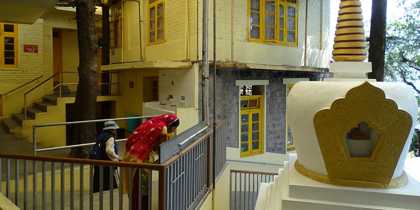 A picture of people praying in the interiors of the Tsuglagkhang Complex