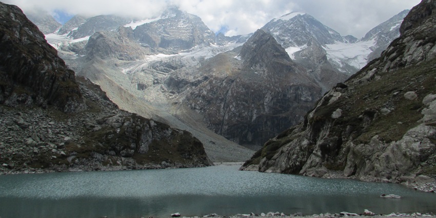 Scenic view of Tulian Lake surrounded by rocky hill trails and misty weather - near zoo in Pahalgam