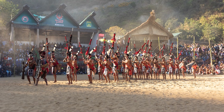 Naga tribesmen and women dressed in their traditional attire dancing during the Hornbill Festival