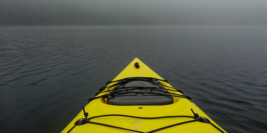 Kayak resting on a peaceful body of water, ready for another paddling adventure in Vietnam.