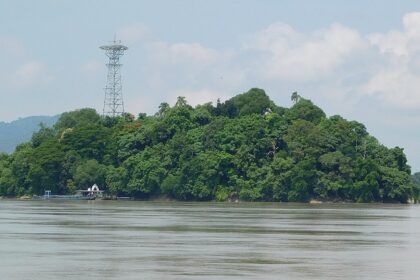 Island with its serene Umananda temple, lush surroundings, and tranquil waters.