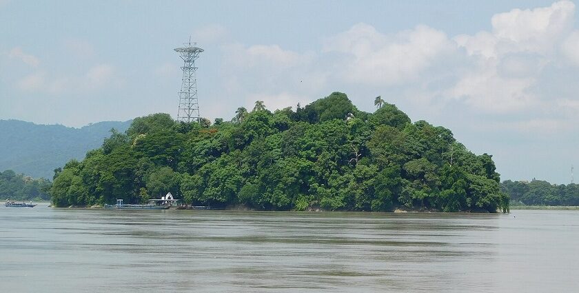 Island with its serene Umananda temple, lush surroundings, and tranquil waters.