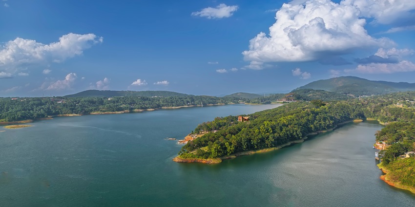 Umiam Lake with tranquil blue waters, surrounded by rolling hills and serene landscapes.