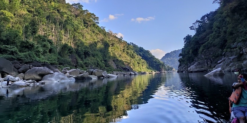 Scenic view of the forested hills reflecting in the Umngot river, ideal place for a peaceful getaway