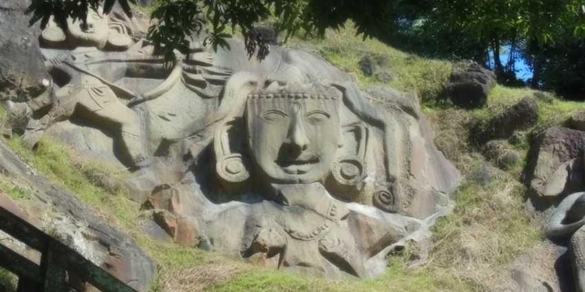 Unakoti Rocks, showcasing ancient rock carvings of deities and intricate sculptures.